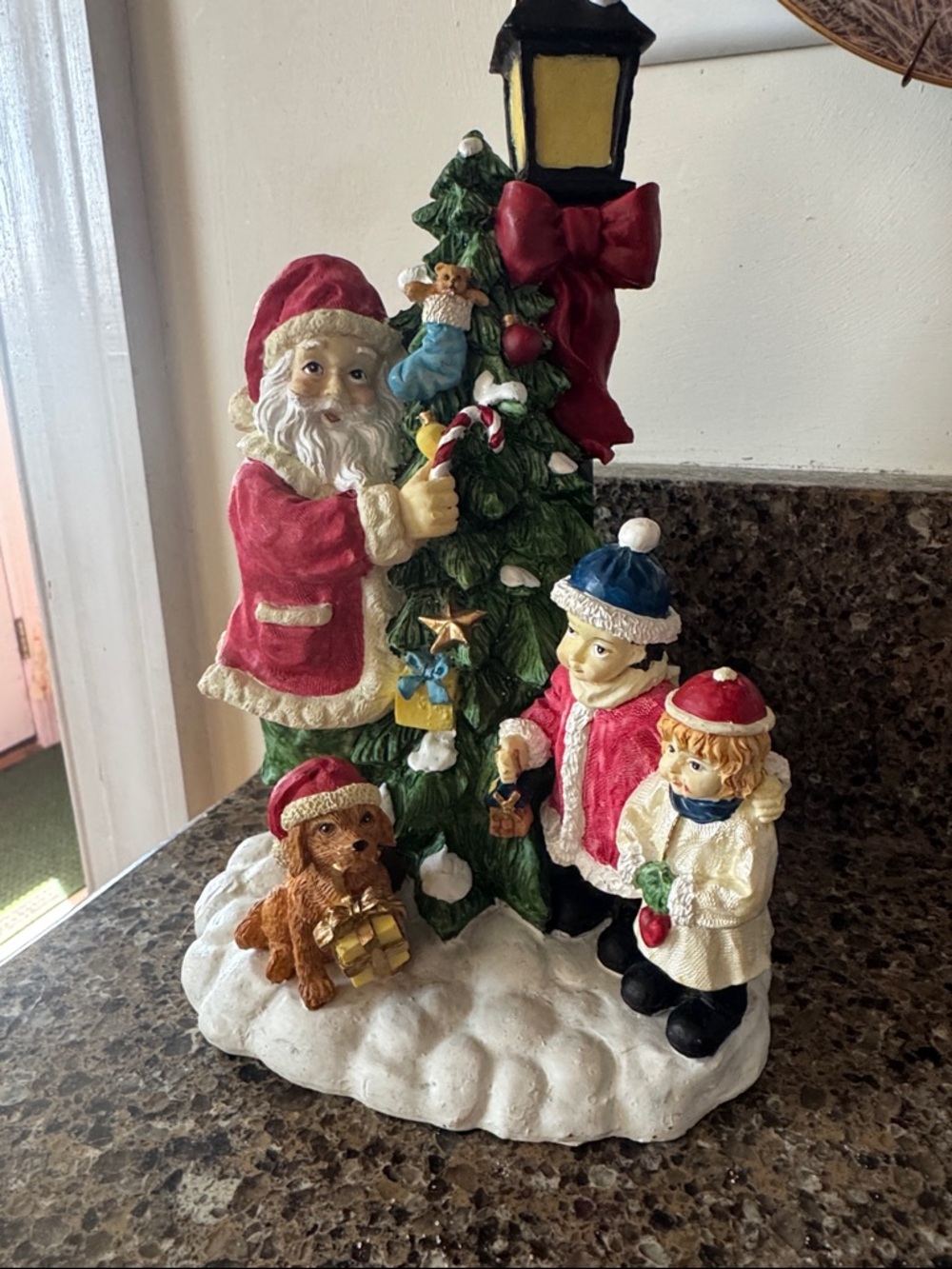 Festive Resin Santa and Children Holiday Figurine